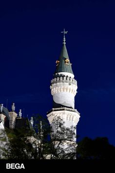 a tall white tower with a cross on top