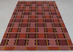 an orange and red rug on the floor