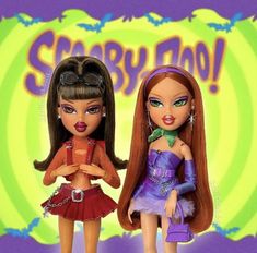 two dolls standing next to each other in front of a sign that says scary boo