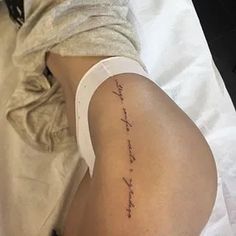 a person laying in bed with a tattoo on their leg that says, i love you to the moon and back