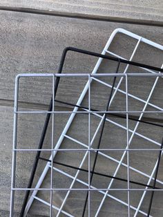 two metal racks sitting on top of a wooden floor