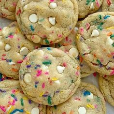 a pile of cookies with sprinkles and white chocolate chips