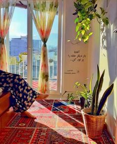 a woman sitting on the floor in front of a window