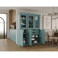 a blue cabinet in the middle of a room next to a dining table and chairs