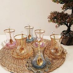 an assortment of glass vases on a tray