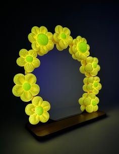 GLOW IN THE DARK! Floral foam Clay mirrors  Each flower is individually handcrafted, mixed with glow powder and coated with a non-toxic sealant that prevents cracking and scratches. The sealant also provides water resistance and protection from UV light. This ensures a longer life for your flowers! You can make your flower mirror glow with natural sunlight, bulb light, or black lights!  These mirrors are perfect for adding some life to your office space, vanity, bedroom, or even to give as a gift!  Item(s) Details:  Round mirror -  * 2 pieces (includes mirror and wood base) * Height: 7.87in / Length: 7.87in (without flowers) Puffy Flower Mirror, Polymer Clay Flower Mirror, Fluffy Clay Flower Mirror, Clay Mirror Frame Flower, Glowing Flower Pendant, Dark Mirror, Flower Mirror, Uv Light, Natural Sunlight