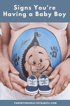 a pregnant woman holding her baby shoes with the words signs you're having a baby boy