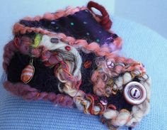 a close up of a cell phone case made out of fabric with buttons on it