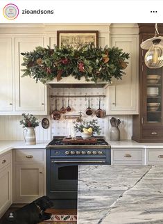 a kitchen with an oven, stove and christmas wreath on the wall above it's burner