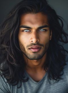 a man with long hair and blue eyes