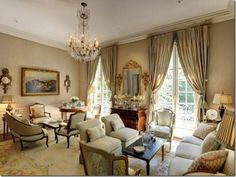 a living room filled with furniture and a chandelier