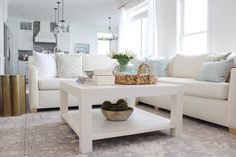 a living room filled with furniture and a white coffee table