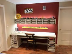 a desk with legos on the wall behind it