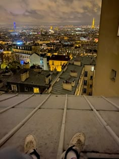 someone is sitting on top of a building looking at the city