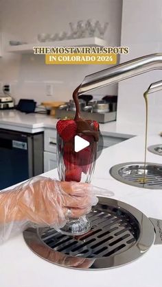 a person pouring some liquid into a blender