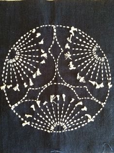 a piece of cloth with white designs on it