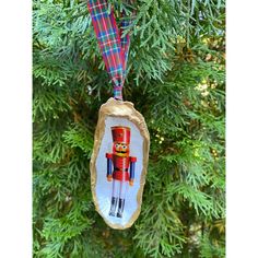 an ornament hanging from a tree with a nutcracker design on it