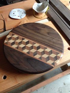 a wooden cutting board sitting on top of a table next to other woodworking tools