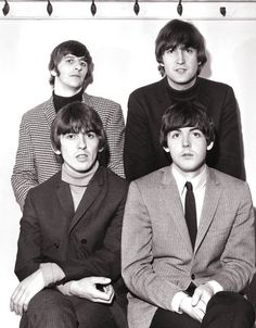 the beatles are posing for a black and white photo in front of a white background