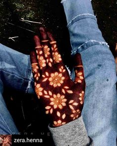 a person with their hands covered in henna