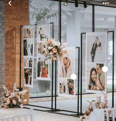 an indoor wedding venue with pictures on the wall and flowers in vases next to them