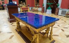 a large blue table sitting in the middle of a room