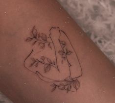 a woman's leg with a tattoo on it that has leaves and a hot dog in the shape of a heart