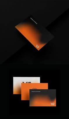 an orange and black business card with the letter v on it, in front of a black background