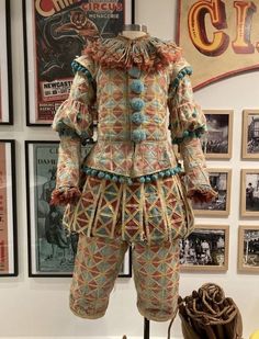 an elaborately decorated suit and hat on display