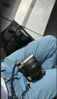 a person laying on the ground with their feet propped up in front of a camera