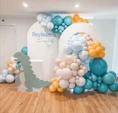 balloons are arranged in the shape of animals and dinosaurs on display at a children's birthday party