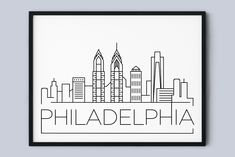 the philadelphia skyline in black and white is featured on a wall above a gray background