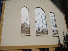 three arched windows on the side of a building