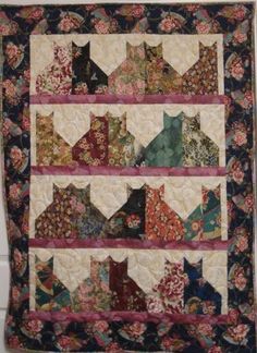 a quilted wall hanging with many different designs on it