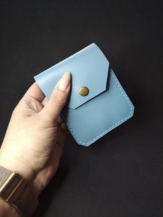 "A compact women's wallet \"Modern\" that is loaded with function, practicality, storage and it is perfect for carrying multi-cards and cash. The wallet is sewed by durable waxed thread of 0,55 mm thick by hands. It is an amazing and useful gift for any occasion: Birthday, Anniversary, Christmas, Valentine's Day, Graduation, Corporate Gift or any other occasion, or simply as an upgrade to your old wallet.   This is purely handmade Can be personalized. Outside material: real leather Kaiser. No lining Closure: 1 snap with brass effect. Features: 1 large compartment for banknotes. 2 compartments for credit, discount, ID cards, drivers license and passport document. Dimensions: Length: 4,3 inches (11 cm) Width: 3,5 inches (8,8 cm) I can sew this wallet in the following colors: - black - brown Blue Trifold Wallet With Coin Pocket For Everyday, Blue Trifold Wallet With Card Slots For Daily Use, Blue Trifold Wallet With Coin Pocket, Blue Trifold Wallet With Rfid Blocking For Everyday Use, Blue Rectangular Trifold Wallet For Everyday Use, Everyday Blue Trifold Wallet With Coin Pocket, Blue Rectangular Leather Coin Purse, Blue Leather Rectangular Coin Purse, Blue Trifold Wallet With Interior Card Slots