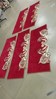 three red rugs with gold designs on them