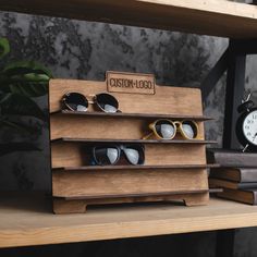 two wooden shelves with sunglasses on each shelf and an alarm clock in the back ground