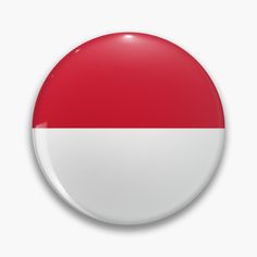 a red and white button on a white background