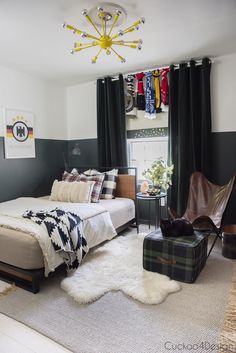 a bed room with a neatly made bed next to a window and a chair in front of it