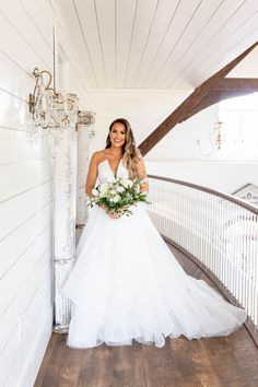 a woman in a white wedding dress holding a bouquet