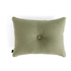 a green pillow with a button on the front and back of it, against a white background