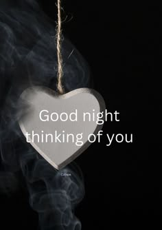 a white heart hanging from a string with the words good night thinking of you