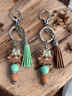 two key chains with charms attached to them