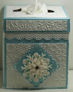 a tissue box decorated with snowflakes and doily