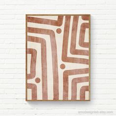 a brown and white abstract painting on a brick wall