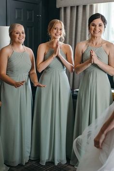 the bridesmaids are clapping together in their dresses