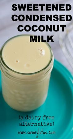 a glass jar filled with coconut milk sitting on top of a blue plate