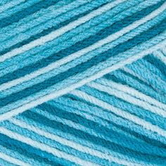 blue and white yarn is shown in close - up view, with the knitting needles visible