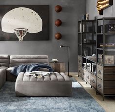 a living room with a sectional couch and basketballs on the wall