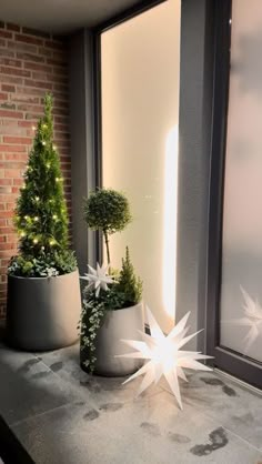 three potted plants sitting on top of a window sill